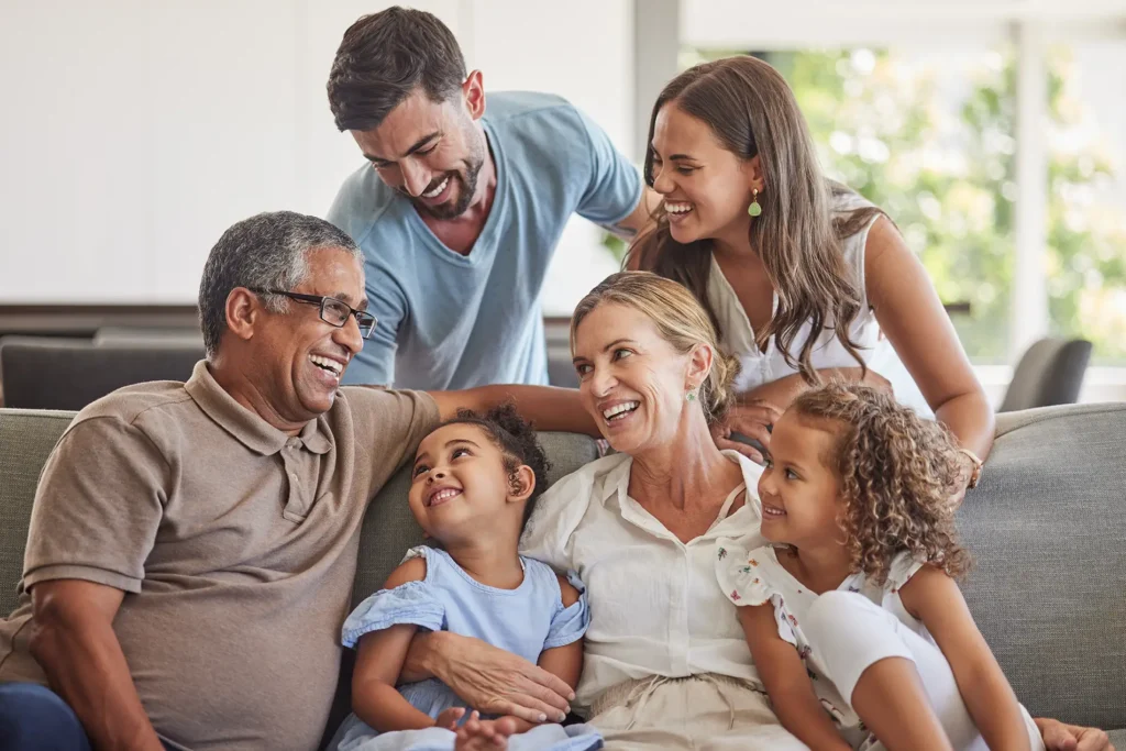 Multigenerational family smiling together on couch – values-based financial planning in Boise