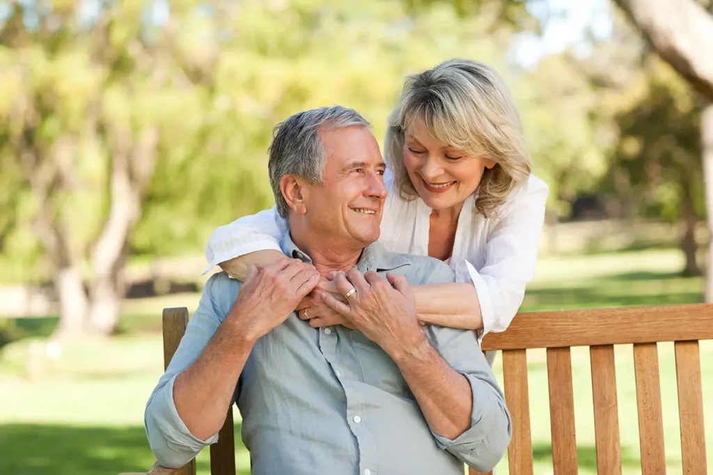 Retired couple relaxing on a park bench in Boise, ID after receiving financial guidance