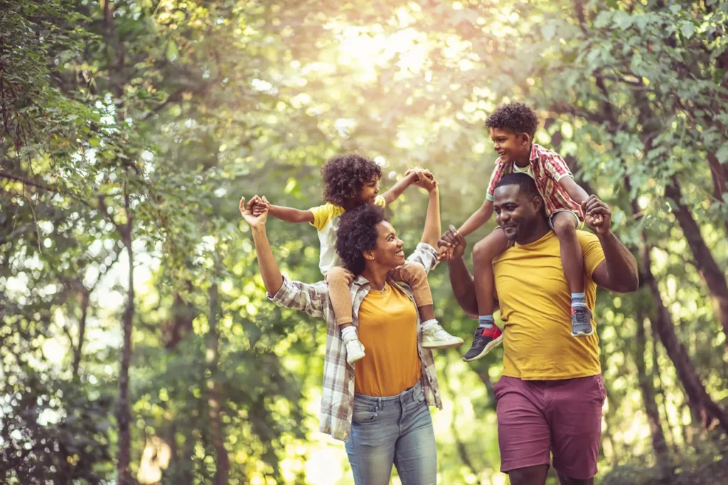 Boise family walking through the woods joyfully discussing their faith-based financial future